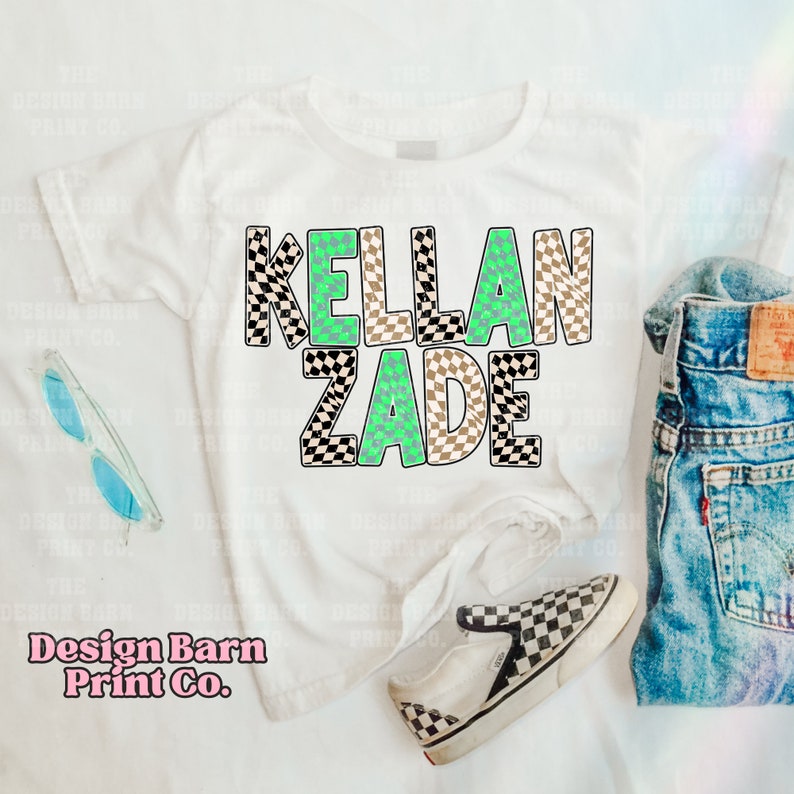 May include: White t-shirt with the name "KELLAN ZADE" printed in black and white checkered letters with green accents.