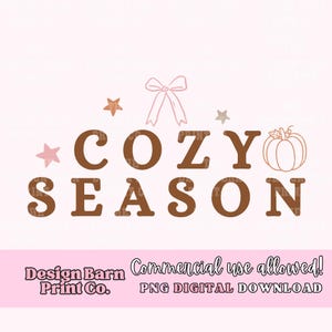 May include: A digital design with the words "COZY SEASON" in brown, accompanied by stars, a bow, and a pumpkin illustration. The design is on a light pink background, with text at the bottom that reads "Design Barn Print Co." and "Commercial use allowed! PNG DIGITAL DOWNLOAD."