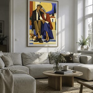 May include: A framed wall art print depicting an elderly couple sitting together on steps with a dog resting at their feet. The illustration features a warm colour palette with yellow, blue, and brown tones, showcasing a Mediterranean landscape.