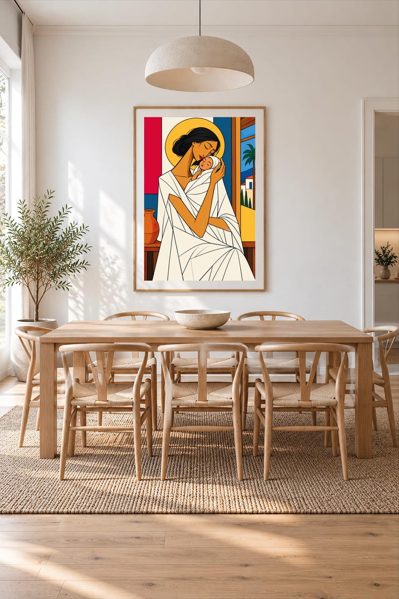 May include: A framed wall art print featuring a stylized illustration of a person in a white robe holding a swaddled infant. The artwork uses bold blocks of red, blue, and yellow, with a golden halo behind the person's head and a palm tree.