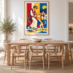 May include: A framed wall art print featuring a colorful illustration of a person in a hat and poncho dancing with a dog on a checkered floor. The background shows a yellow sun, blue sky, and white buildings with red roofs in a bright, graphic style.