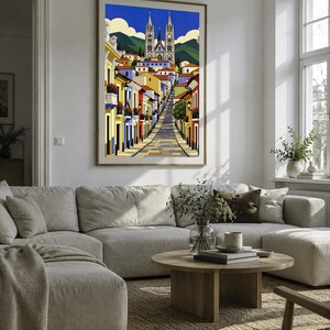 May include: A framed vertical art print depicting a colorful street scene leading toward a large gothic-style cathedral with twin spires. The illustration features vibrant yellow, blue, and red buildings under a bright blue sky with white clouds.