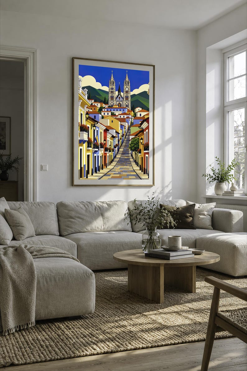 May include: A framed vertical art print depicting a colorful street scene leading toward a large gothic-style cathedral with twin spires. The illustration features vibrant yellow, blue, and red buildings under a bright blue sky with white clouds.
