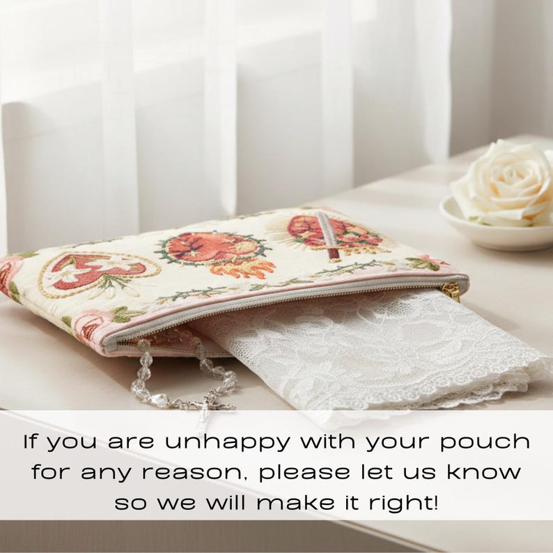 May include: A cream-colored pouch with a floral and heart design, a pink zipper, and a gold zipper pull. A white lace item is partially visible inside. A rosary and a white rose are also present.