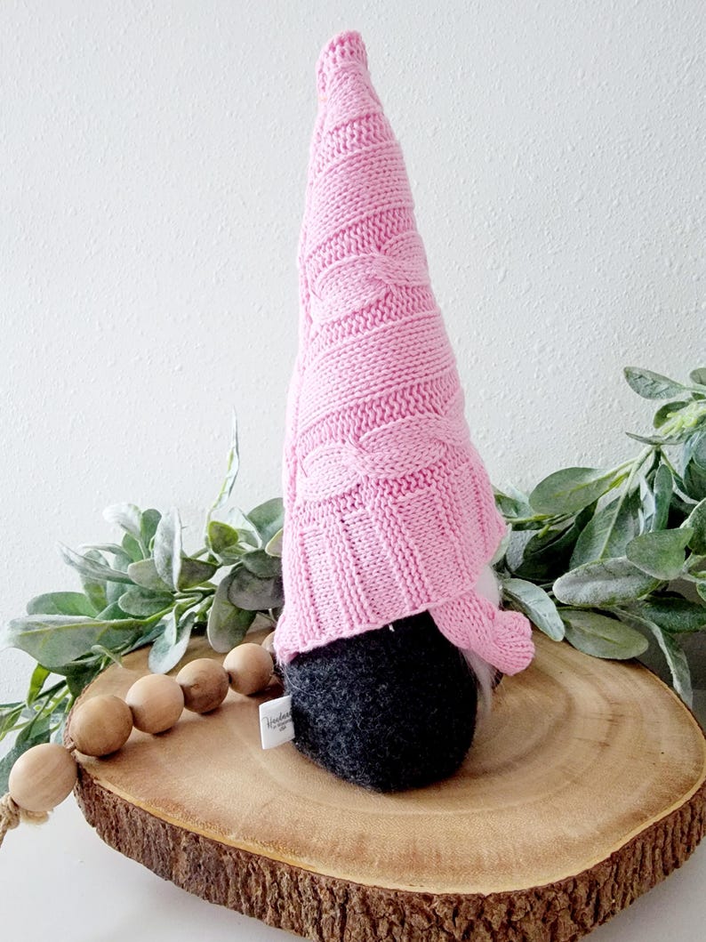Gnome shown with side view to shiw a tag seen in the back seam.