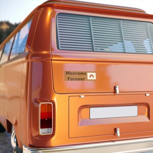 May include: A vintage orange van with a sticker that reads "Macrame Forever" with a rainbow graphic. The van has a rear window with blinds and a blank license plate.