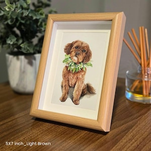 May include: A watercolor painting of a brown dog wearing a flower lei. The painting is framed in a light brown wood frame. The frame is 5x7 inches.