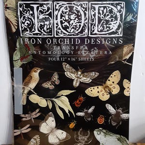 May include: A black sheet featuring various insect and bird illustrations, including butterflies, moths, beetles, and a frog. The text "IRON ORCHID DESIGNS TRANSFER ENTOMOLOGY ETCETERA" is printed on the sheet. The sheet measures 12" x 16".