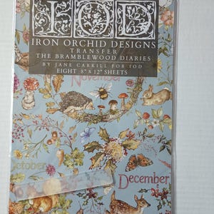 May include: A pack of eight 20.3 cm by 30.5 cm Iron Orchid Designs transfer sheets titled The Bramblewood Diaries by Jane Carkill. The light blue sheets feature illustrations of woodland animals, mushrooms, flowers, and the months October, November, and December.