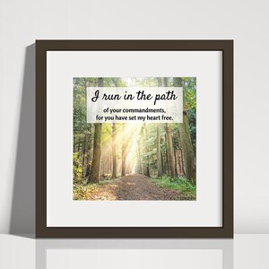 May include: A framed print with a quote about running in the path of your commandments. The quote is set against a background image of a sunlit path through a forest.