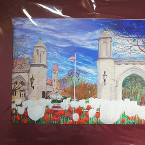 May include: A painting of a white stone archway with a red brick walkway leading to a building with a clock tower. The archway is decorated with white tulips and red tulips. The sky is blue with white clouds.