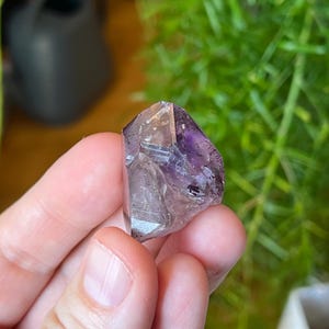 Multiple enhydros (trapped moving water bubbles!) in beautiful smoky amethyst Crystal from Goboboseb, Namibia