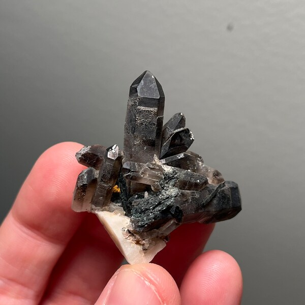 Gorgeous smoky quartz with aegirine and feldspar from Mt Malosa, Malawi. Killer phantoms!