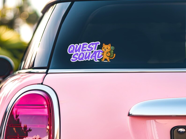 May include: A pink car with a purple and white sticker on the back window. The sticker says 'Quest Squad' and features a cartoon cat wearing a backpack.