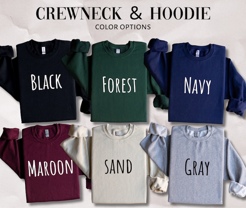 Puede incluir: Seis sudaderas de cuello redondo en diferentes colores: negro, verde bosque, azul marino, granate, arena y gris. Las sudaderas est&aacute;n dispuestas sobre una superficie texturizada.  CREW NECK & HOODIE COLOR OPTIONS est&aacute; escrito en la parte superior de la imagen.