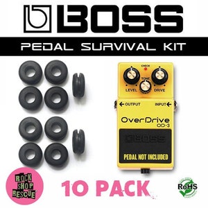 May include: A 10 pack of black rubber pedalboard grommets with a yellow Boss Overdrive OD-3 pedal in the background. The pedal has a black text label that reads "Over Drive OD-3". The pedal has knobs for level, tone, and drive. The text "PEDAL NOT INCLUDED" is printed on the pedal.