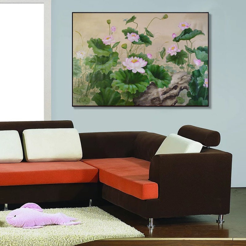 May include: A painting of pink lotus flowers with green leaves and a brown branch in the foreground. The background is a light beige color.