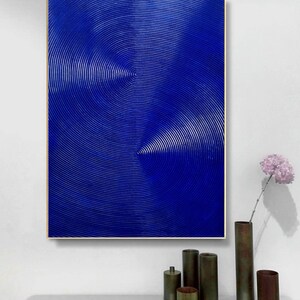 May include: Abstract painting with a blue background and concentric circles in a textured pattern.