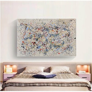 May include: Abstract expressionist painting with a beige background and a chaotic arrangement of colorful paint splatters. The artwork features black, red, yellow, blue, and gray paint, creating a dynamic and energetic composition. The painting is rectangular and framed.
