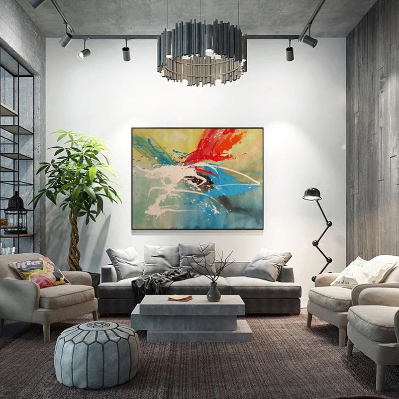 May include: A living room with a grey sofa, two armchairs, a coffee table, and a large abstract painting on the wall. The painting features splashes of red, blue, yellow, and white paint.