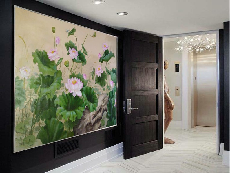 May include: A painting of pink lotus flowers and green leaves on a beige background. The painting is framed and hanging on a wall in a hallway.