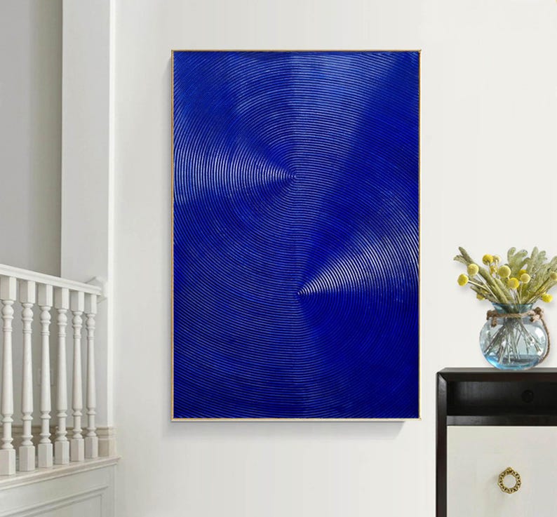 May include: Abstract painting with a blue background and concentric circles in a white and light blue pattern.