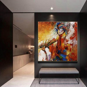 May include: Abstract painting of a woman in a colorful costume holding a fan. The background is a mix of yellow, orange, and red.