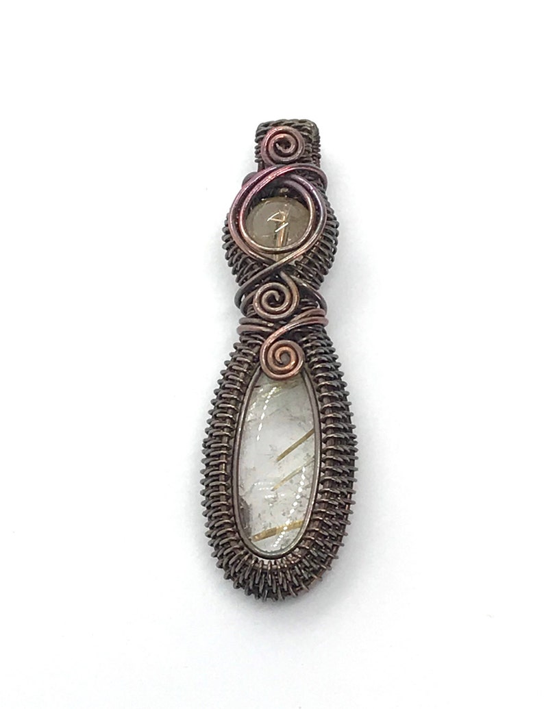 May include: A wire-wrapped pendant featuring a clear quartz crystal with gold inclusions. The pendant is made with copper wire and has a brown and iridescent finish.