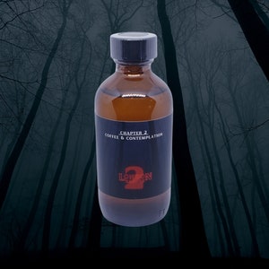 May include: A brown glass bottle with a black cap. The bottle is labeled "Chapter 2 Coffee & Contemplation" and has a red and black logo that says "London 2".