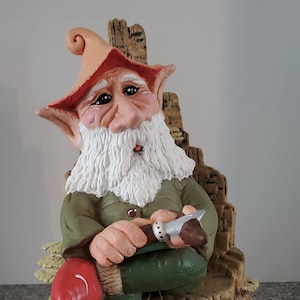 Gome sitting on throne chair spending time whittling on soft wood.  Shipping included in price.