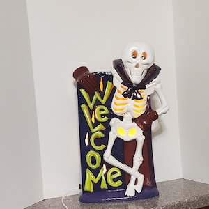 Skeleton Welcome Sign with lights.  Offering a Cute Halloween Welcome and Goodbye with this 2-sided sign.