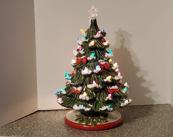 Christmas Tree Ceramic 15inches w/ stand; Painted,Decorated w/ ribbons and light source, ready to add to your decor.Price includes Shipping.