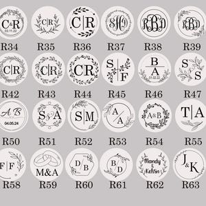 May include: A set of 64 round wax seal stamps with various designs, including initials, hearts, and floral motifs. The stamps are arranged in rows with a number below each stamp.