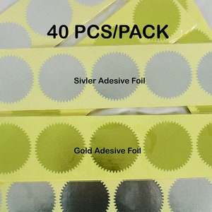 May include: A pack of 40 self-adhesive gold and silver foil seals. The seals are round and have a scalloped edge. The pack includes two sheets of seals, one sheet with gold seals and one sheet with silver seals. The text "40 PCS/PACK" is printed on the top of the pack. The text "Siviver Adesive Foil" is printed on the sheet of silver seals. The text "Gold Adesive Foil" is printed on the sheet of gold seals.
