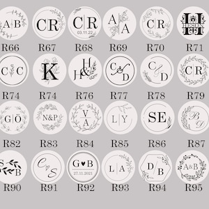 May include: A set of 96 round wax seal stamps with various designs and initials. The stamps are arranged in a grid pattern with a white background. Each stamp has a different design, including initials, flowers, hearts, and other decorative elements. The stamps are made of metal and have a wooden handle.