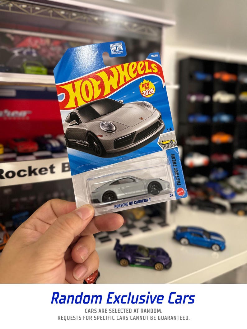 May include: A silver Porsche 911 Carrera T Hot Wheels die-cast car in its original packaging. The packaging is blue and features the Hot Wheels logo and the text "NEW 2026". The car is part of the "Factory Fresh" series.