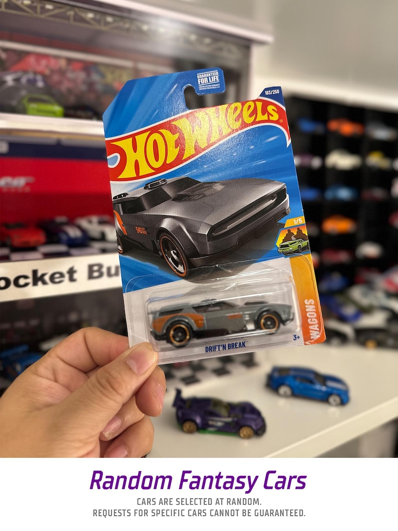 May include: A gray Hot Wheels die-cast car in its original packaging. The car is a Drift'n Break model, part of the Wagons series, and is number 183 of 250. The packaging features the Hot Wheels logo and the text "GUARANTEED FOR LIFE".