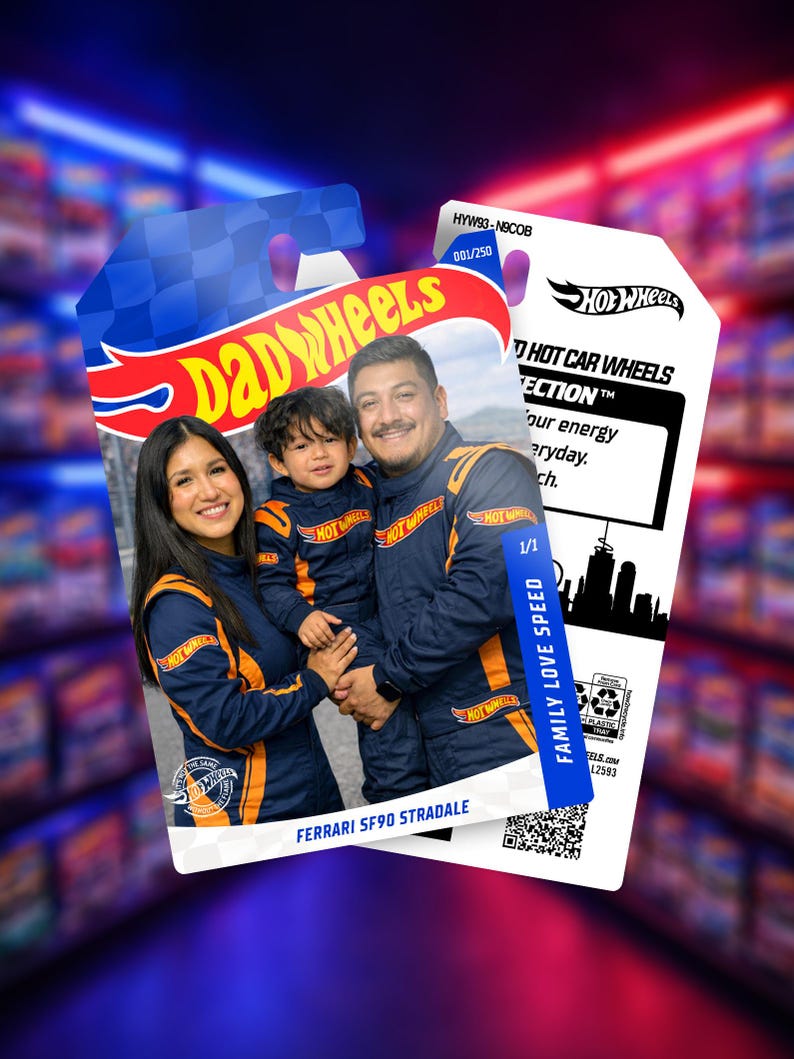 May include: A Hot Wheels card featuring a family in matching blue and orange racing suits. The card has the Hot Wheels logo and text that reads "DAD WHEELS" and "FERRARI SF90 STRADALE". The card also has the text "FAMILY LOVE SPEED".
