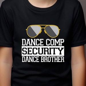 May include: A black t-shirt with a white graphic of sunglasses and the text "Dance Comp Security Dance Brother".