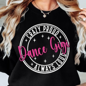 May include: Black sweatshirt with a white circle graphic that says "Crazy Proud Dance Gigi Always Loud" in white text with the word "Gigi" in pink text.