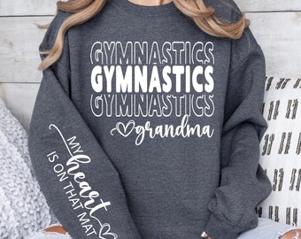 May include: Gray sweatshirt with the text "Gymnastics Gymnastics Gymnastics grandma" on the front and "My heart is on that mat" on the sleeve.