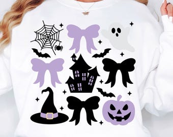 May include: White sweatshirt with Halloween-themed graphics. Features a spiderweb, bats, bows, a haunted house, a witch's hat, a ghost, and a jack-o'-lantern. The graphics are in black, purple, and white.