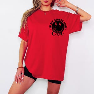 May include: Red oversized t-shirt with a black graphic that says "In My Sports Mom Eva" with lightning bolts.