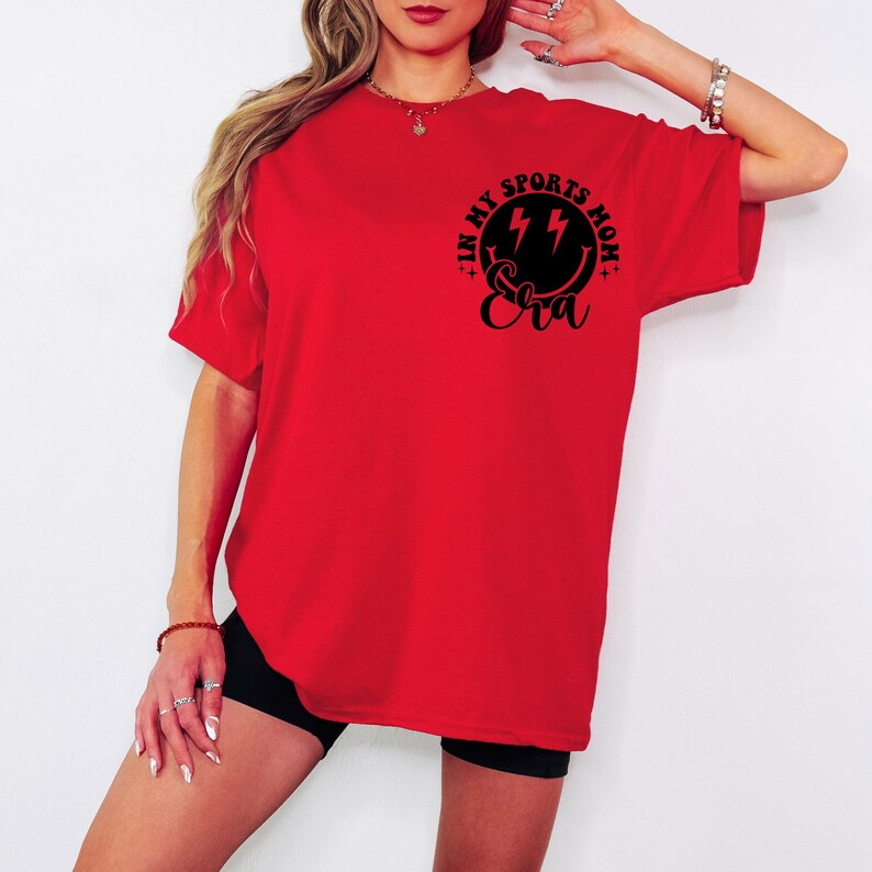 May include: Red oversized t-shirt with a black graphic that says "In My Sports Mom Eva" with lightning bolts.