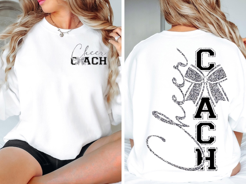 May include: White sweatshirt with "Cheer Coach" text in black and silver glitter. The front features the text "Cheer Coach" with a bow graphic. The back has a large bow graphic and the word "Coach" vertically.