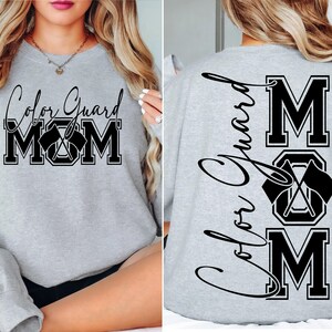 May include: Gray sweatshirt with the text "Color Guard Mom" on the front and "Color Guard Mom" with a crossed flag design on the back.