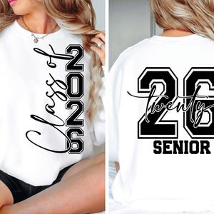 May include: White sweatshirt with black lettering. The front reads "Class of 2026" vertically. The back displays "26 Twenty SENIOR". A stylish and comfortable garment for the graduating class of 2026.