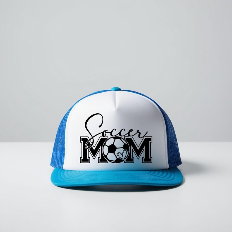 May include: A white and blue trucker hat with a black and white graphic that says "Soccer Mom" with a soccer ball in the middle of the word "Mom".