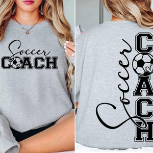 May include: Grey sweatshirt with the text "Soccer Coach" on the front and the text "Soccer Coach" vertically down the back with a football graphic.