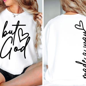 May include: White sweatshirt with the text "but God" and a heart on the front and the text "made a way" on the back.